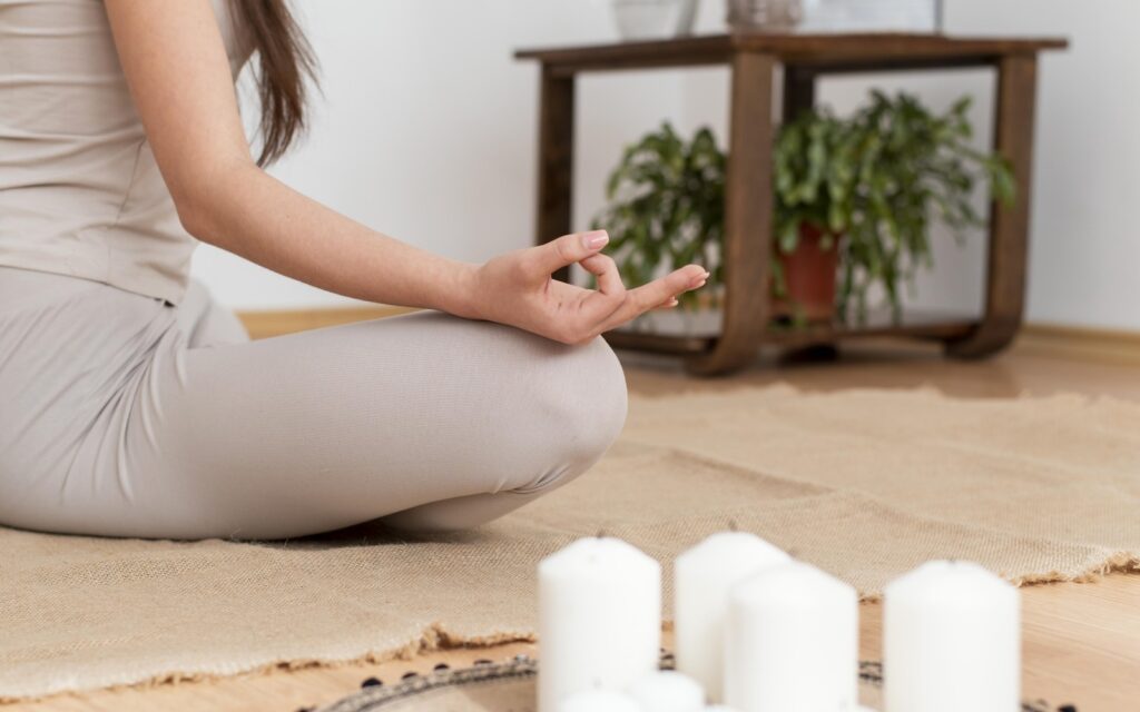 Meditation 1 woman meditating with tray with candles
